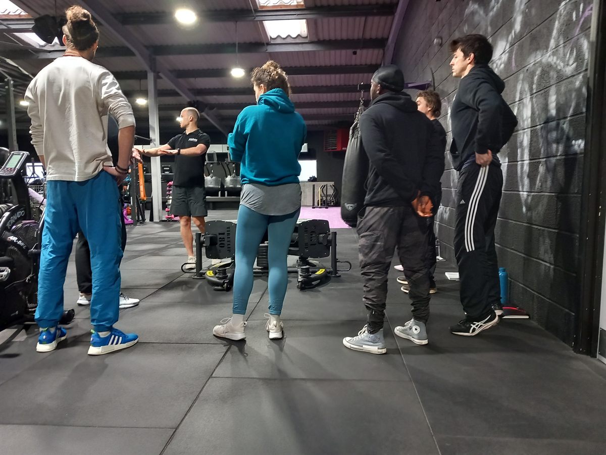 Personal training students watching a live coaching demonstration at Wellbeing Fitness, Towcester